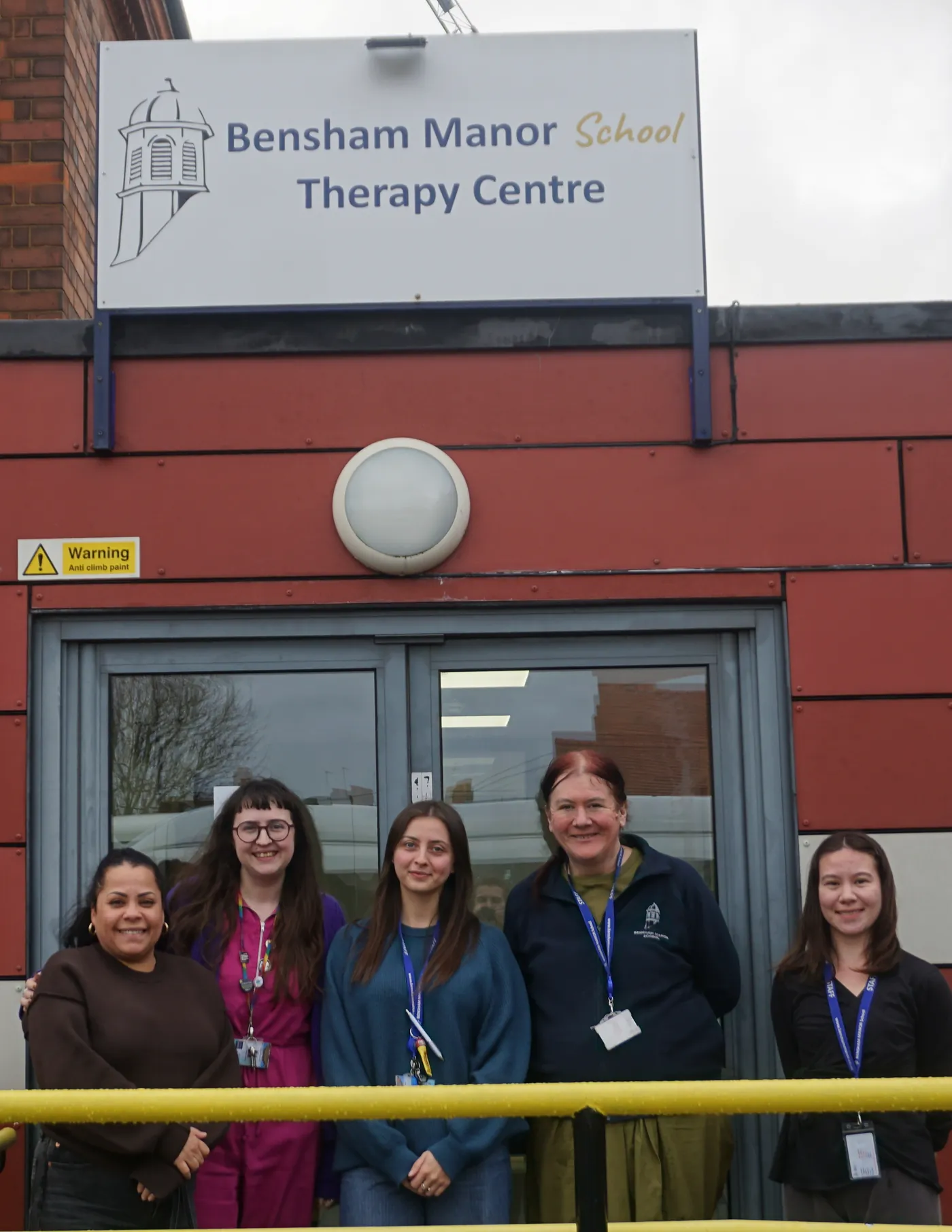 Five members of the therapy team standing together outside the entrance to the Bensham Manor School Therapy Centre.